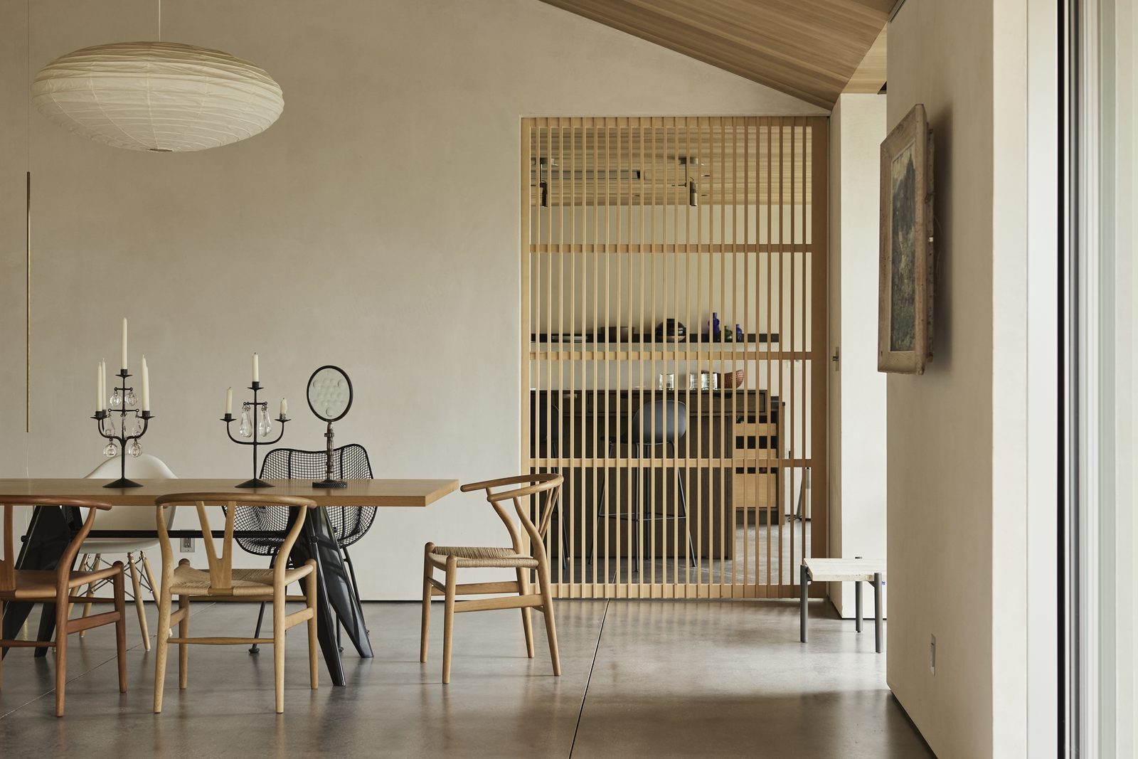 Slatted timber screen dividing a dining room