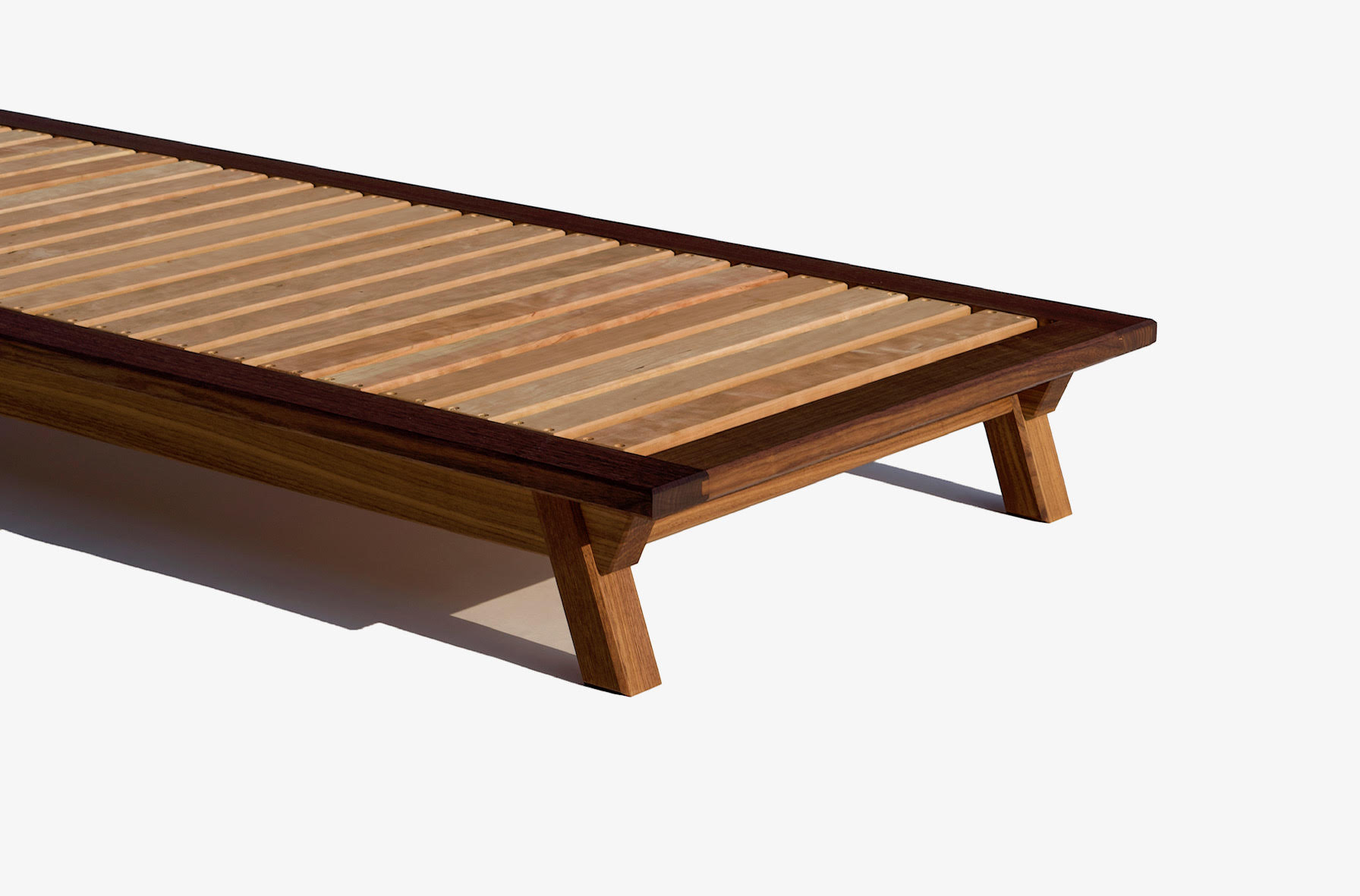 Low platform bed frame in walnut with cherry slats