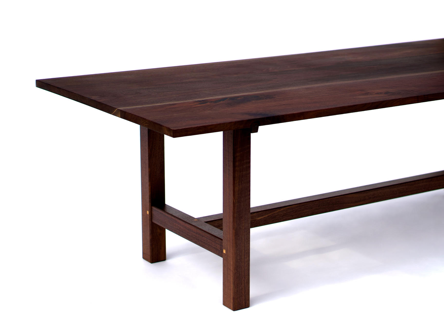 Walnut table on a pegged stretcher base, with inlaid keys