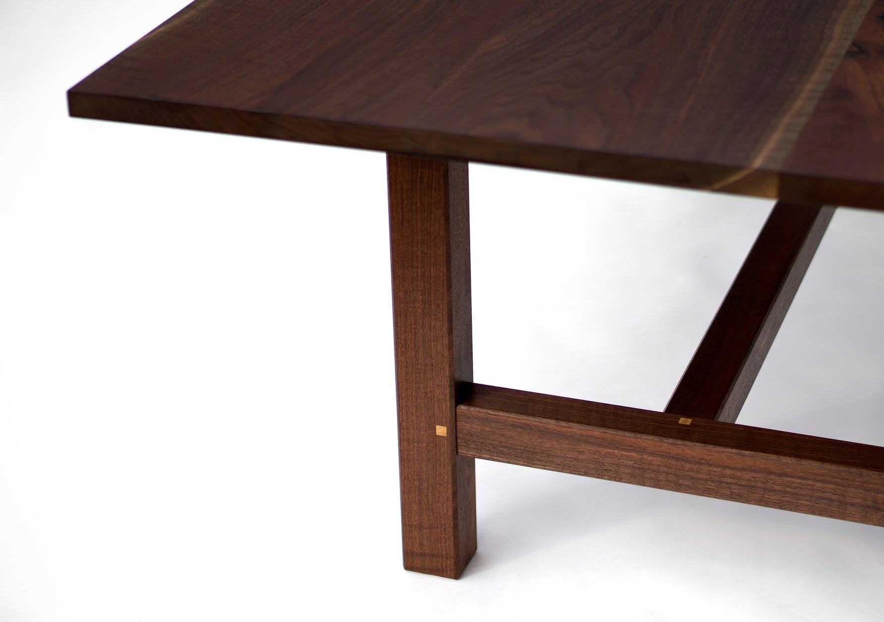 Detail of a table leg and stretcher, joined with square pegs