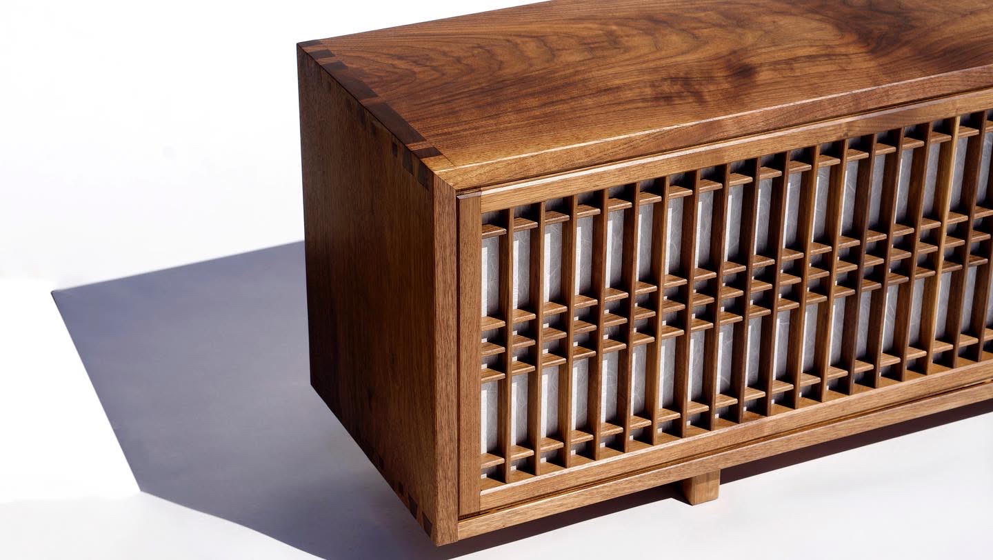 Corner of a walnut cabinet, dovetailed, with kumiko lattice over paper