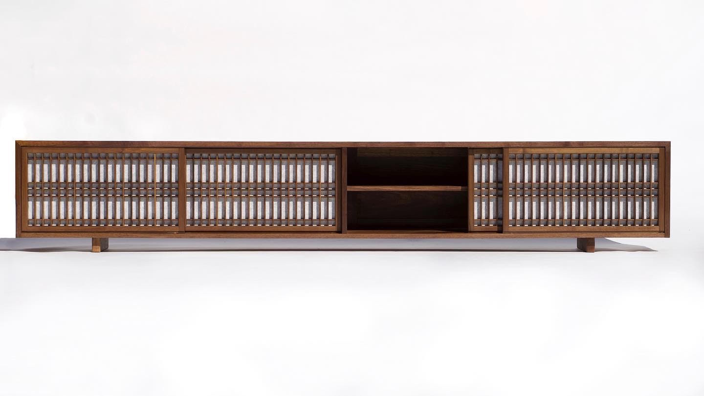 Long low cabinet in walnut with kumiko lattice sliding doors