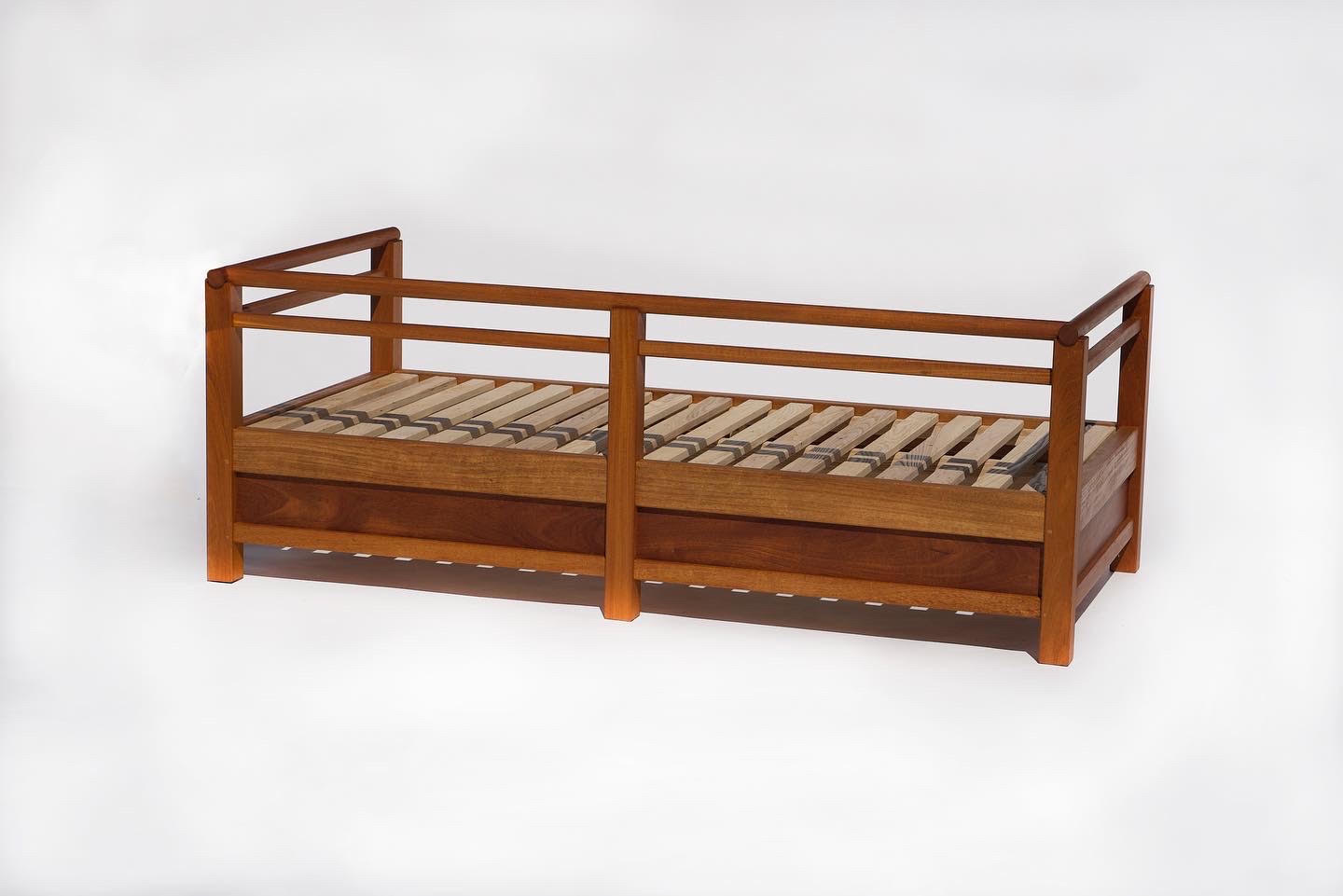 Child’s bed with turned rails and a slatted base